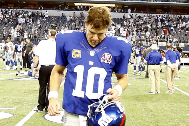 Oct 19, 2014; Arlington, TX, USA; New York Giants quarterback Eli Manning (10) leaves the field after the game against the Dallas Cowboys at AT&T Stadium. Dallas beat New York 31-21. Mandatory Credit: Tim Heitman-USA TODAY Sports