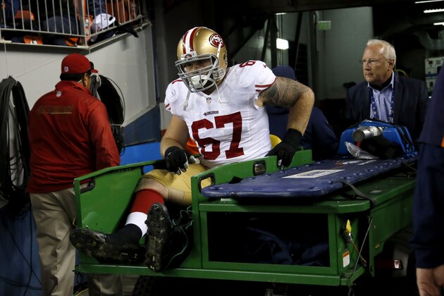 San Francisco 49ers center Daniel Kilgore (67) is carted off the field after being injured against the Denver Broncos during the first half of an NFL football game, Sunday, Oct. 19, 2014, in Denver.  (AP Photo/Jack Dempsey)
