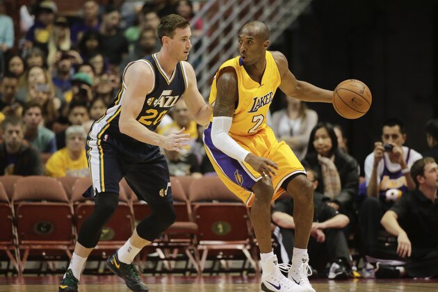 Los Angeles Lakers' Kobe Bryant, right, is defended by Utah Jazz's Gordon Hayward during the first half of a preseason NBA basketball game Thursday, Oct. 16, 2014, in Anaheim, Calif. (AP Photo/Jae C. Hong)