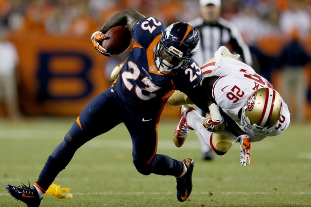 Denver Broncos running back Ronnie Hillman (23) is hit by San Francisco 49ers cornerback Tramaine Brock (26) during the first half of an NFL football game, Sunday, Oct. 19, 2014, in Denver.  (AP Photo/Joe Mahoney)