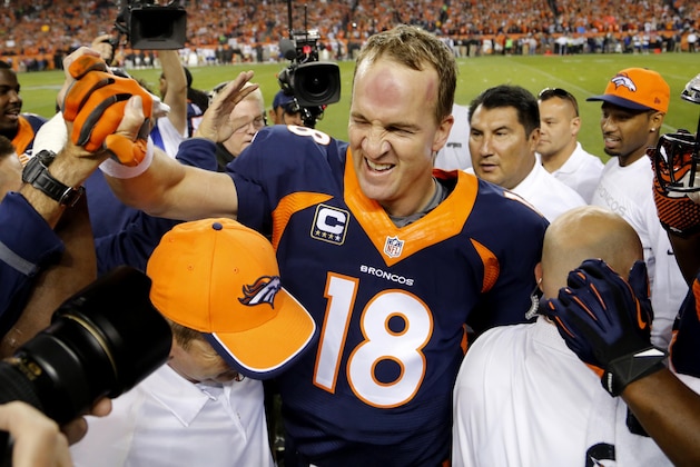 Denver Broncos quarterback Peyton Manning (18) celebrates his 509th career touchdown pass with teammates during the first half of an NFL football game against the San Francisco 49ers, Sunday, Oct. 19, 2014, in Denver.  (AP Photo/Jack Dempsey)