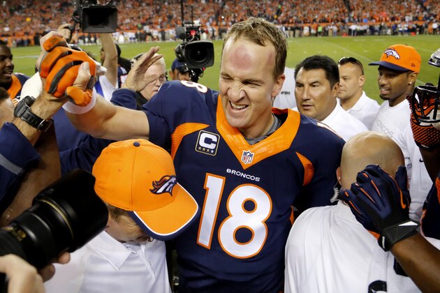 Denver Broncos quarterback Peyton Manning (18) celebrates his 509th career touchdown pass with teammates during the first half of an NFL football game against the San Francisco 49ers, Sunday, Oct. 19, 2014, in Denver.  (AP Photo/Jack Dempsey)