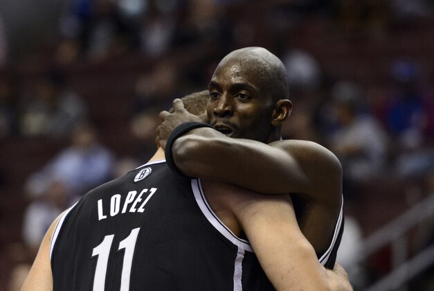 Oct 14, 2013; Philadelphia, PA, USA; Brooklyn Nets forward Kevin Garnett (2) hugs center Brook Lopez (11) during the second quarter against the Philadelphia 76ers at Wells Fargo Center. The Nets defeated the Sixers 127-97. Mandatory Credit: Howard Smith-USA TODAY Sports