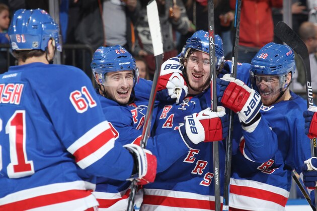 NEW YORK, NY - OCTOBER 19:  Kevin Hayes #13 of the New York Rangers celebrates with Rick Nash #61, Chris Kreider #20 and Marc Staal #18 of the New York Rangers after scoring his first NHL goal in the third period against the San Jose Sharks at Madison Square Garden on October 19, 2014 in New York City. (Photo by Jared Silber/NHLI via Getty Images)
