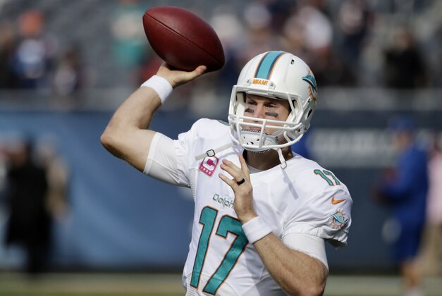 Miami Dolphins quarterback Ryan Tannehill (17) warms up before an NFL football game against the Chicago Bears Sunday, Oct. 19, 2014 in Chicago. (AP Photo/Charles Rex Arbogast)