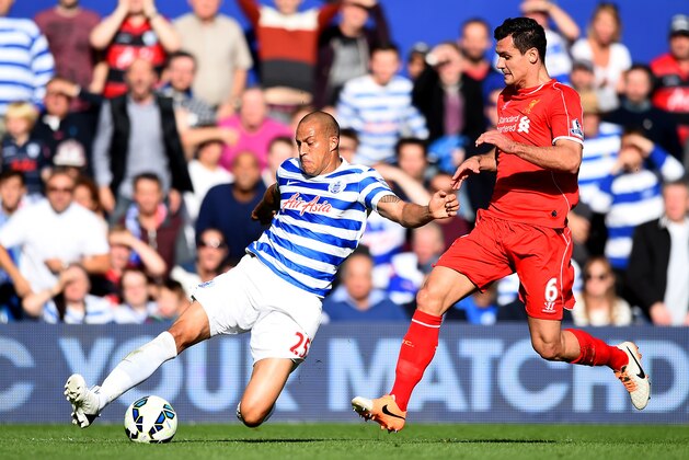 LONDON, ENGLAND - OCTOBER 19:  Bobby Zamora of QPR slides for the ball next to Dejan Lovren of Liverpool during the Barclays Premier League match between Queens Park Rangers and Liverpool at Loftus Road on October 19, 2014 in London, England.  (Photo by Paul Gilham/Getty Images)