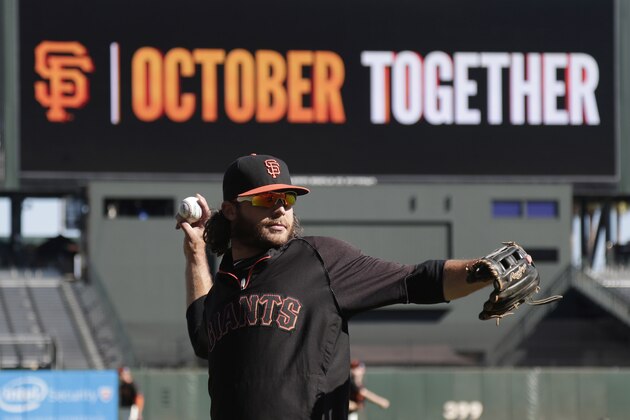 San Francisco Giants shortstop Brandon Crawford warms up during a team workout on Saturday, Oct. 18, 2014, in San Francisco.  The Giants are scheduled to play the Kansas City Royals in Game 1 of baseball's World Series on Tuesday, Oct. 21, in Kansas City. (AP Photo/Marcio Jose Sanchez)