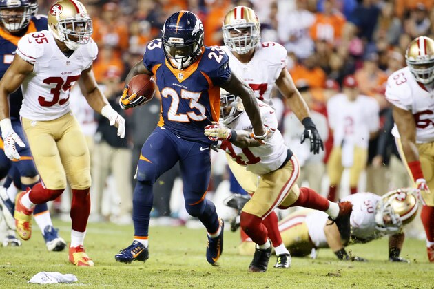 Denver Broncos running back Ronnie Hillman (23) runs for a touchdown as San Francisco 49ers strong safety Antoine Bethea (41) tries to make the tackle during the first half of an NFL football game, Sunday, Oct. 19, 2014, in Denver.  (AP Photo/Jack Dempsey)