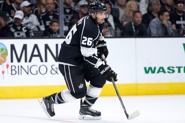 LOS ANGELES, CA - OCTOBER 08:  Slava Voynov #26 of the Los Angeles Kings starts a rush during the game against the San Jose Sharks at Staples Center on October 8, 2014 in Los Angeles, California.  (Photo by Harry How/Getty Images)
