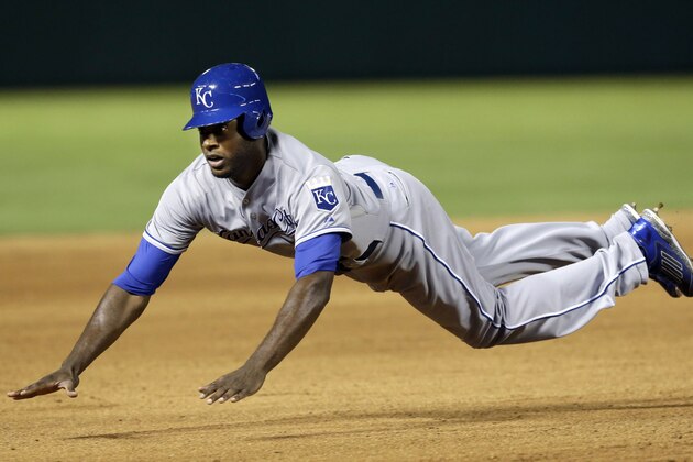 Kansas City Royals' Lorenzo Cain dives to safely steal third base during the seventh inning of a baseball game against the Texas Rangers, Friday, Aug. 22, 2014, in in Arlington, Texas. The Royals won 6-3. (AP Photo/LM Otero)