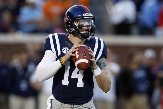 Mississippi quarterback Bo Wallace (14) drops back to pass against Tennessee in the first half of an NCAA college football game in Oxford, Miss., Saturday, Oct. 18, 2014. (AP Photo/Rogelio V. Solis)