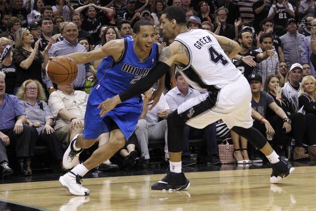 SAN ANTONIO, TX - MAY 4:  Devin Harris #20 of the Dallas Mavericks drives around Danny Green #4 of the San Antonio Spurs in Game Seven of the Western Conference Quarterfinals during the 2014 NBA Playoffs at the AT&T Center on May 4, 2014 in San Antonio, Texas. NOTE TO USER: User expressly acknowledges and agrees that, by downloading and/or using this photograph, user is consenting to the terms and conditions of the Getty Images License Agreement. (Photo by Chris Covatta/Getty Images)