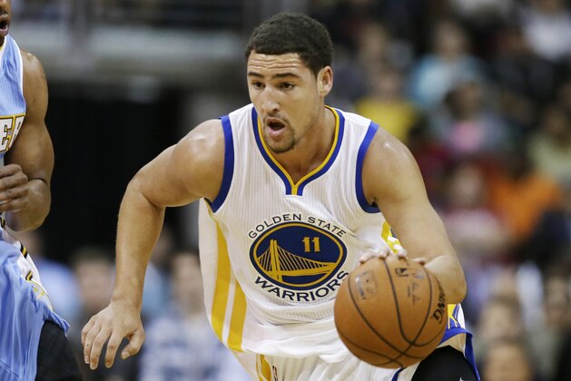 Golden State Warriors guard Klay Thompson, right, drives past Denver Nuggets guard Arron Afflalo during the first half of a preseason NBA basketball game, Thursday, Oct. 16, 2014, in Des Moines, Iowa. (AP Photo/Charlie Neibergall)