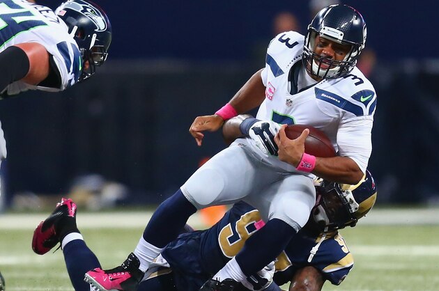 ST. LOUIS, MO - OCTOBER 19: Russell Wilson #3 of the Seattle Seahawks is sacked by Eugene Sims #97 of the St. Louis Rams in the second quarter at the Edward Jones Dome on October 19, 2014 in St. Louis, Missouri.  (Photo by Dilip Vishwanat/Getty Images)
