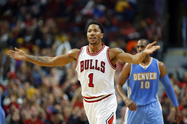 Chicago Bulls guard Derrick Rose (1) reacts to the crowd after making a three point basket against the Denver Nuggets during the first half of a pre-season NBA basketball game in Chicago, on Monday Oct. 13, 2014. (AP Photo/Jeff Haynes)