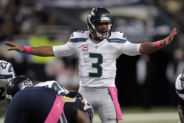 Seattle Seahawks quarterback Russell Wilson yells on the line of scrimmage during the fourth quarter of an NFL football game against the St. Louis Rams Sunday, Oct. 19, 2014, in St. Louis. (AP Photo/Tom Gannam)