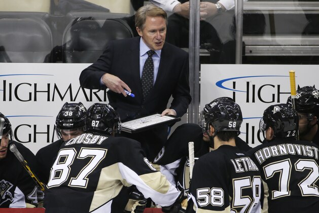 Pittsburgh Penguins head coach Mike Johnston gives instructions during a time out in the third period of  an NHL hockey game against the New York Islanders in Pittsburgh, Saturday, Oct. 18, 2014. The Penguins won 3-1. (AP Photo/Gene J. Puskar)
