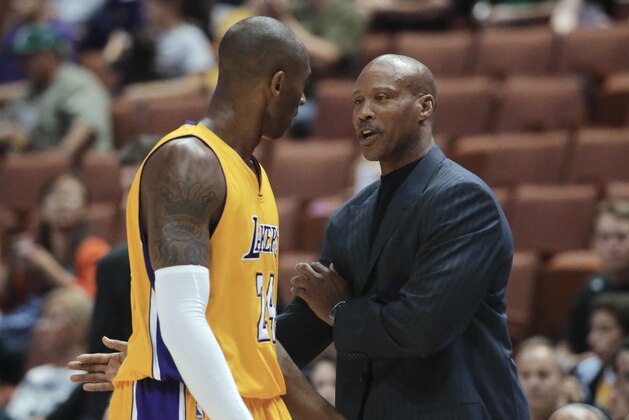 Los Angeles Lakers coach Byron Scott, right, talks to Kobe Bryant during the first half of a preseason NBA basketball game against the Utah Jazz on Thursday, Oct. 16, 2014, in Anaheim, Calif. (AP Photo/Jae C. Hong)