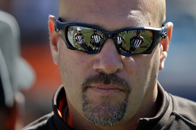 Cleveland Browns head coach Mike Pettine talks to a group of officials before the start of an NFL football game against the Jacksonville Jaguars, Sunday, Oct. 19, 2014, in Jacksonville, Fla. The Jaguars beat the Browns 24-6. (AP Photo/Stephen B. Morton)