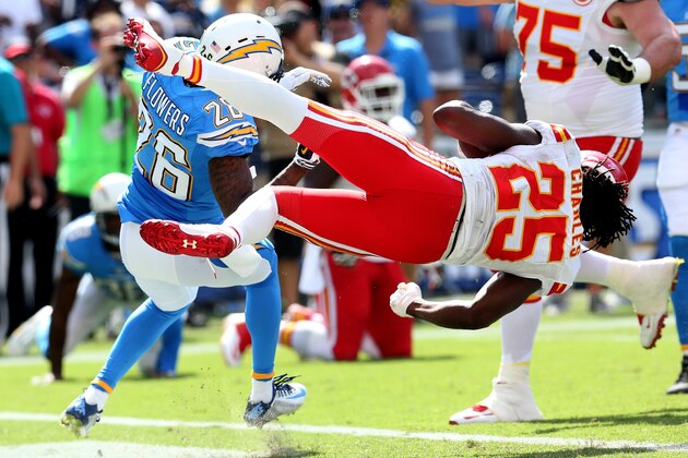 SAN DIEGO, CA - OCTOBER 19:  Running back Jamaal Charles #25 of the Kansas City Chiefs dives around cornerback Brandon Flowers #26 of the San Diego Chargers to score a touchdown to finish a 16 yard run in the second quarter at Qualcomm Stadium on October 19, 2014 in San Diego, California.  (Photo by Stephen Dunn/Getty Images)