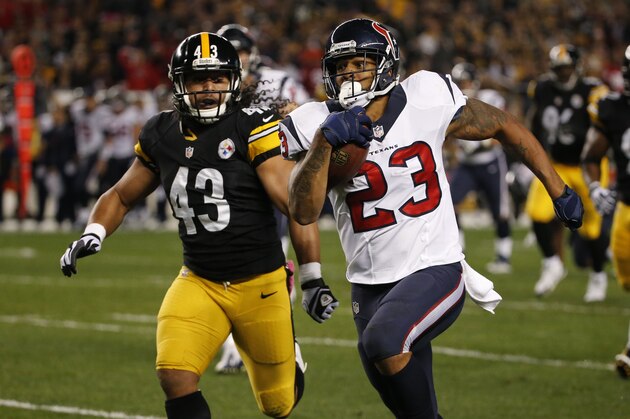Houston Texans running back Arian Foster (23) runs past Pittsburgh Steelers strong safety Troy Polamalu (43) in the first quarter of the NFL football game against the Pittsburgh Steelers, Monday, Oct. 20, 2014 in Pittsburgh. (AP Photo/Gene J. Puskar)
