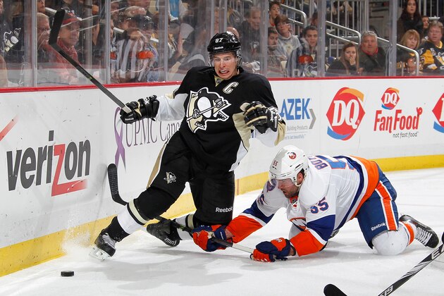PITTSBURGH, PA - OCTOBER 18: Sidney Crosby #87 of the Pittsburgh Penguins battles for the puck with Johnny Boychuk #55 of the New York Islanders during the third period at Consol Energy Center on October 18, 2014 in Pittsburgh, Pennsylvania.  (Photo by Gregory Shamus/NHLI via Getty Images)