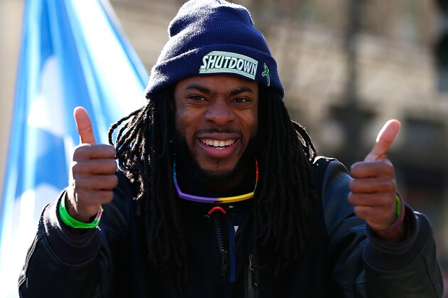 SEATTLE - FEBRUARY 05:  Richard Sherman #25 of the Seattle Seahawks celebrates their victory in Super Bowl XLVII during a parade on February 5, 2014 in Seattle, Washington.  (Photo by Jonathan Ferrey/Getty Images)