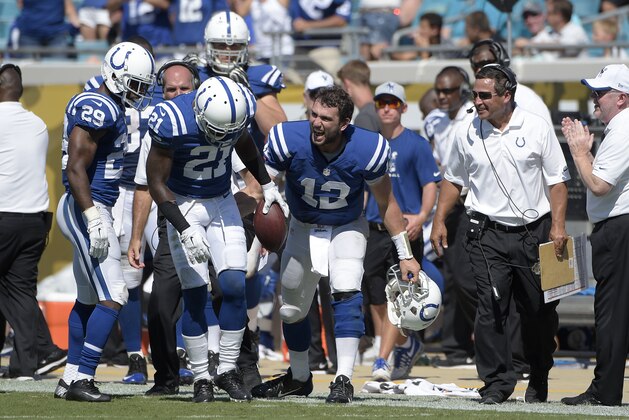 Indianapolis Colts cornerback Vontae Davis (21) is congratulated by quarterback Andrew Luck (12) after intercepting a pass intended for Jacksonville Jaguars wide receiver Allen Robinson during the second half of an NFL football game in Jacksonville, Fla., Sunday, Sept. 21, 2014.(AP Photo/Phelan M. Ebenhack)