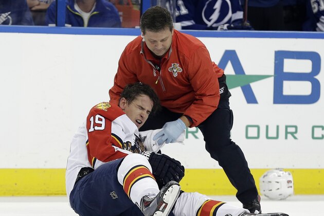 Florida Panthers right wing Scottie Upshall (19) is helped by a trainer after getting hurt against the Tampa Bay Lightning during the second period of an NHL hockey game Thursday, Oct. 9, 2014, in Tampa, Fla. (AP Photo/Chris O'Meara)