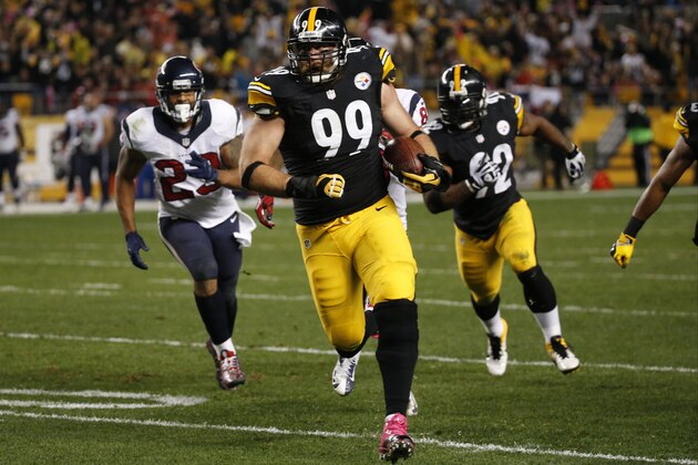 Pittsburgh Steelers defensive end Brett Keisel (99) runs past Houston Texans running back Arian Foster (23) after intercepting a pass in the second quarter of the NFL football game, Monday, Oct. 20, 2014 in Pittsburgh. (AP Photo/Gene J. Puskar)