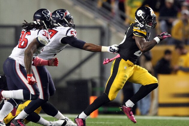 Oct 20, 2014; Pittsburgh, PA, USA; Pittsburgh Steelers running back Le'Veon Bell (26) runs the ball past Houston Texans safety D.J. Swearinger (36) and linebacker Justin Tuggle (57) during the second half at Heinz Field. The Steelers won the game, 30-23. Mandatory Credit: Jason Bridge-USA TODAY Sports