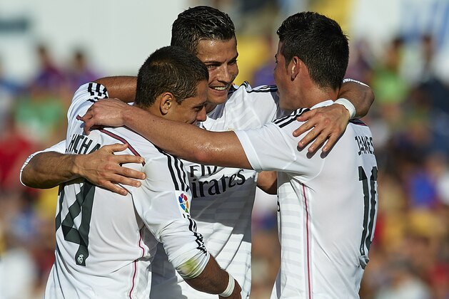 VALENCIA, SPAIN - OCTOBER 18:  Cristiano Ronaldo of Real Madrid celebrates after scoring with his teammates  Javier 'Chicharito' Hernandez (L) and James Rodriguez (R) during the La Liga match between Levante UD and Real Madrid at Ciutat de Valencia on October 18, 2014 in Valencia, Spain.  (Photo by Manuel Queimadelos Alonso/Getty Images)