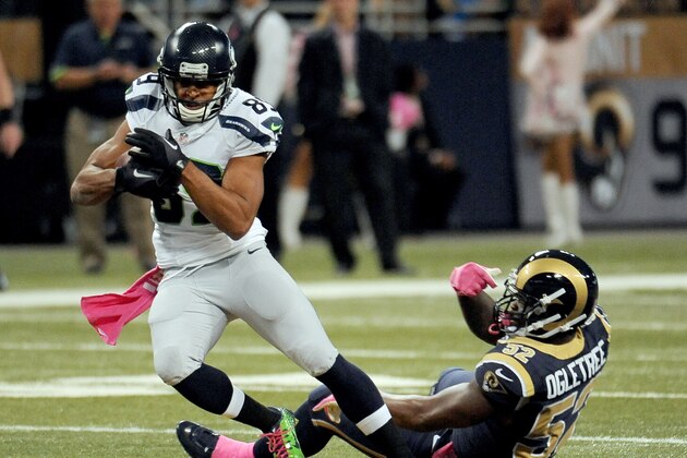 Seattle Seahawks wide receiver Doug Baldwin, left, slips past St. Louis Rams linebacker Alec Ogletree after catching a pass for a 49-yard gain during the first quarter of an NFL football game Sunday, Oct. 19, 2014, in St. Louis. (AP Photo/L.G. Patterson)