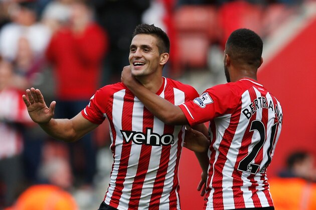 SOUTHAMPTON, ENGLAND - OCTOBER 18:  Dusan Tadic (11) and Ryan Bertrand of Southampton (21) celebrate during the Barclays Premier League match between Southampton and Sunderland at St Mary's Stadium on October 18, 2014 in Southampton, England.  (Photo by Steve Bardens/Getty Images)
