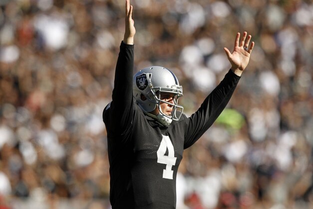 Oct 19, 2014; Oakland, CA, USA; Oakland Raiders quarterback Derek Carr (4) reacts after running back Darren McFadden (not pictured) rushed for a touchdown against the Arizona Cardinals in the second quarter at O.co Coliseum. Mandatory Credit: Cary Edmondson-USA TODAY Sports