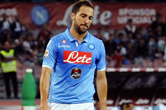 Napoli's  Gonzalo Higuain walks on the pitch during a Serie A soccer match between Napoli and Torino, at the San Paolo stadium in Naples, Italy, Sunday, Oct. 5, 2014. (AP Photo/Salvatore Laporta)