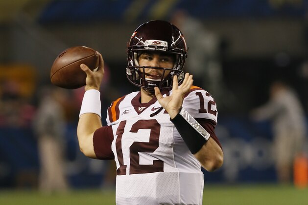 Virginia Tech quarterback Michael Brewer (12) warms up before the NCAA football game against Pittsburgh, Thursday, Oct. 16, 2014 in Pittsburgh. (AP Photo/Keith Srakocic)