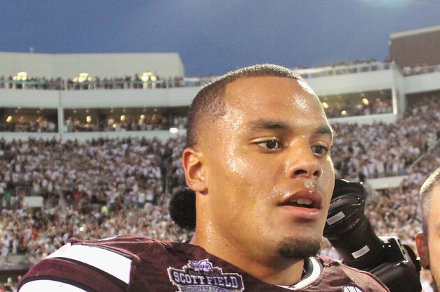 Mississippi State quarterback Dak Prescott (15) walks through off the field following their 38-23 win over No. 2 Auburn in an NCAA college football game in Starkville, Miss., Saturday, Oct. 11, 2014. (AP Photo/Jim Lytle)