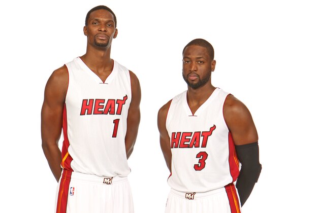 MIAMI, FL - SEPTEMBER 26: Chris Bosh #1 and Dwyane Wade #3 of the Miami Heat pose for a portrait during 2014 Media Day at the America Airlines Arena in Miami, Florida. NOTE TO USER: User expressly acknowledges and agrees that, by downloading and/or using this photograph, user is consenting to the terms and conditions of the Getty Images License Agreement. Mandatory copyright notice: Copyright NBAE 2014 (Photo by Issac Baldizon/NBAE via Getty Images)