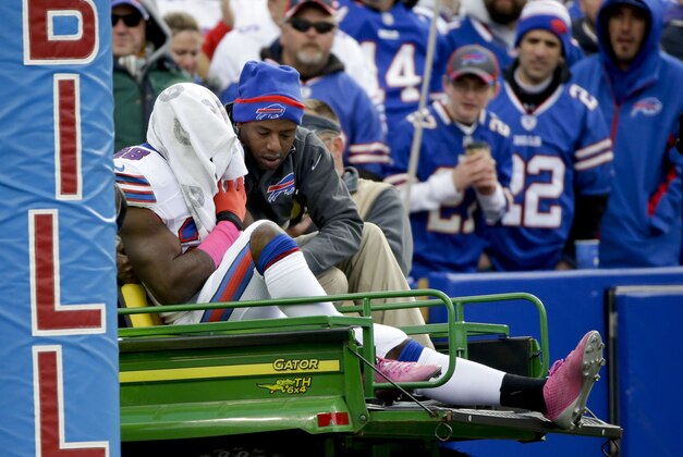 FILE - In this Oct. 19, 2014, file photo, Buffalo Bills running back C.J. Spiller is comforted as he is carted off the field with a towel over his head during the first half of an NFL football game against the Minnesota Vikings  in Orchard Park, N.Y. The Bills lost starting running backs Fred Jackson and Spiller to injuries. (AP Photo/Bill Wippert, File)