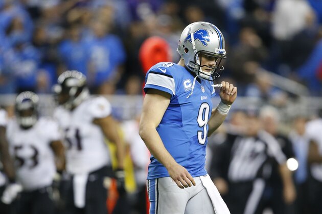 Detroit Lions quarterback Matthew Stafford (9) walks off the field after Baltimore Ravens free safety Matt Elam (26) intercepted his pass during the fourth quarter of an NFL football game in Detroit, Monday, Dec. 16, 2013. (AP Photo/Rick Osentoski)