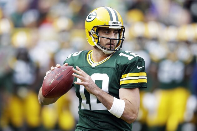Green Bay Packers' Aaron Rodgers drops back during the first half of an NFL football game against the Carolina Panthers Sunday, Oct. 19, 2014, in Green Bay, Wis. (AP Photo/Tom Lynn)