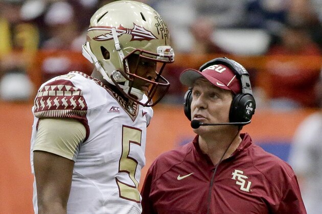 Florida State head coach Jimbo Fisher, right, talks to quarterback Jameis Winston (5) during the second half of an NCAA college football game against Syracuse, Saturday, Oct. 11, 2014, in Syracuse, N.Y. Florida State won the game 38-20. (AP Photo/Frank Franklin II)