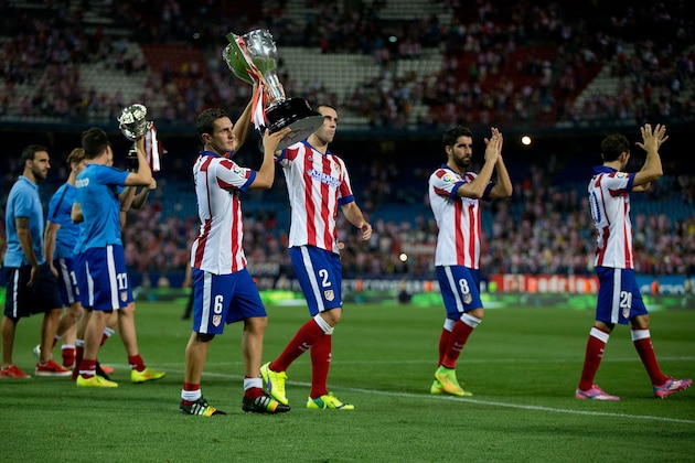 MADRID, SPAIN - AUGUST 30: Koke (L) of Atletico de Madrid holds the La Liga cup with his teammate Diego Godin (R) during the celebration held after the La Liga match between Club Atletico de Madrid and SD Eibar at Vicente Calderon Stadium on August 30, 2014 in Madrid, Spain.  (Photo by Gonzalo Arroyo Moreno/Getty Images)