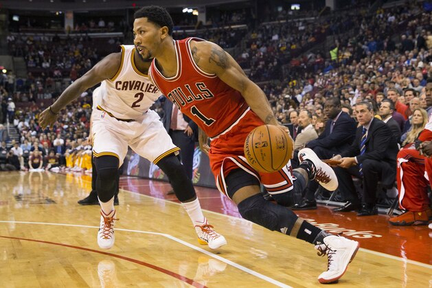 Oct 20, 2014; Columbus, OH, USA; Chicago Bulls guard Derrick Rose (1) drives past Cleveland Cavaliers guard Kyrie Irving (2) at Value City Arena. Cleveland won the game 107-98. Mandatory Credit: Greg Bartram-USA TODAY Sports