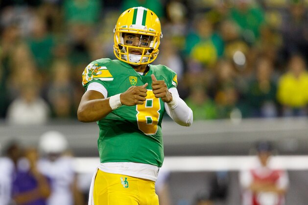 Oregon quarterback Marcus Mariota (8) looks to the sideline for a play during the fourth quarter against Washington in an NCAA college football game in Eugene, Ore., Saturday, Oct. 18, 2014. (AP Photo/Ryan Kang)