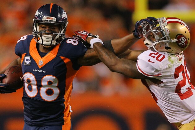 DENVER, CO - OCTOBER 19:  Wide receiver Demaryius Thomas #88 of the Denver Broncos puts a stiff arm on cornerback Perrish Cox #20 of the San Francisco 49ers on a 49-yard reception during a game at Sports Authority Field at Mile High on October 19, 2014 in Denver, Colorado.  (Photo by Justin Edmonds/Getty Images)