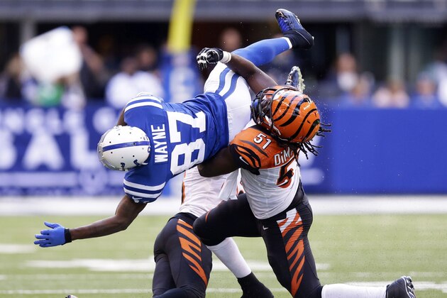 Indianapolis Colts wide receiver Reggie Wayne (87) is tackled by Cincinnati Bengals linebacker Jayson DiManche (51) during the second half of an NFL football game, Sunday, Oct. 19, 2014, in Indianapolis. (AP Photo/Michael Conroy)
