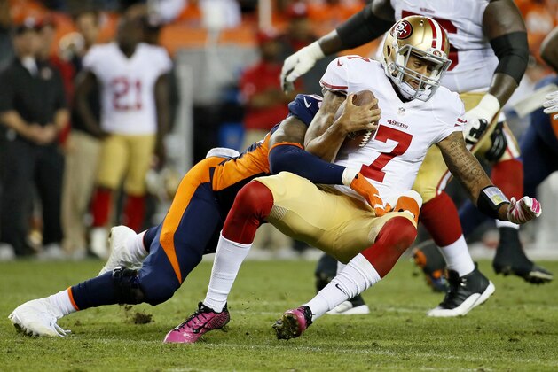 Denver Broncos outside linebacker Von Miller, rear, tackles San Francisco 49ers quarterback Colin Kaepernick (7) during the second half of an NFL football game, Sunday, Oct. 19, 2014, in Denver. (AP Photo/Jack Dempsey)