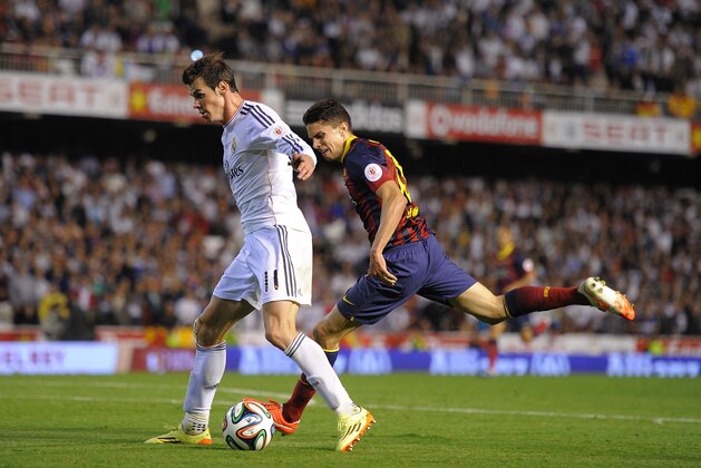 VALENCIA, SPAIN - APRIL 16:  Gareth Bale (L) of Real Madrid beats  Marc Bartra   of Barcelona to score Real's 2nd goal during the  Copa del Rey Final between Real Madrid and Barcelona at Estadio Mestalla on April 16, 2014 in Valencia, Spain.  (Photo by Denis Doyle/Getty Images)